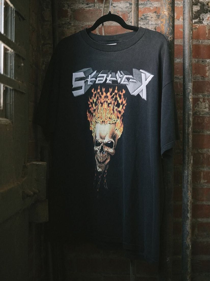 A vintage Static-X tee shirt on a hanger against the painted brick wall at 6 Foot Closet